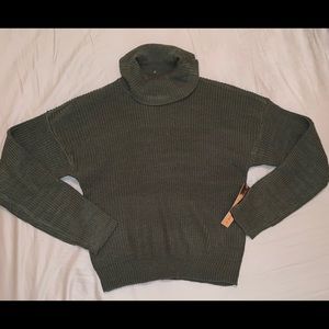 A dark olive green turtleneck shirt.